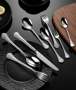 Hammered stainless steel cutlery detail, luxury relief knife fork and spoon set display.