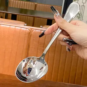 Stainless steel serving spoon detail view, long handle restaurant tableware for food service.