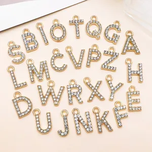 Dettaglio di ciondoli con lettere in strass KC, pendenti per gioielli fai da te creativi.