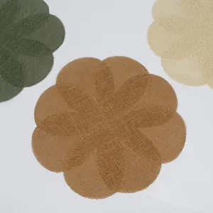 Close-up view of woven petal placemats showing detailed texture and fine edge stitching.