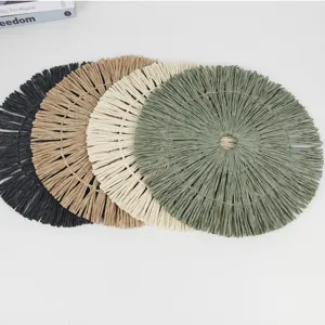 Round paper woven placemat with fringe, stylish heat-resistant dining table pad for home decor.