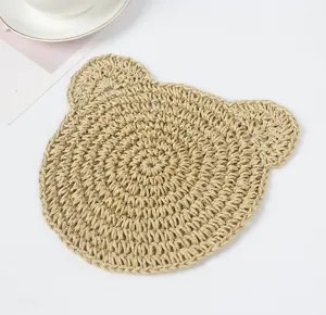 Handmade paper rope crochet bear placemat detail, cute beige coaster for dining table decor.