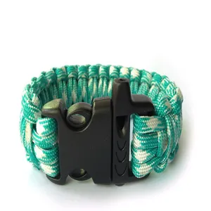 Outdoor survival paracord bracelet with whistle buckle, green and white woven design.