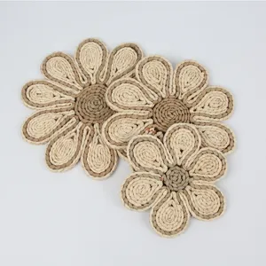 Handcrafted straw woven flower placemat detail, natural plant fiber bohemian coaster for home decor.