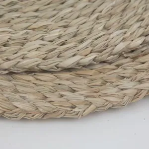 Close up of woven seagrass placemat texture, natural straw table mat detail view.