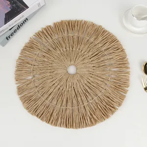 Detailed close-up of round paper woven placemat featuring textured fringe and center hole.