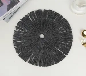 Black paper woven round placemat with fringe tassels, perfect for dining table decor and heat insulation.
