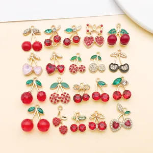 Detailed view of various red cherry alloy rhinestone pendant DIY jewelry making accessories.