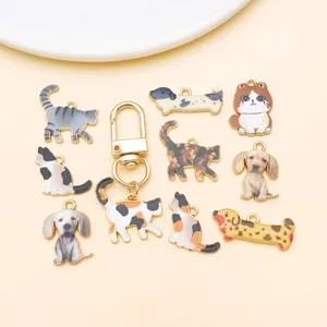 Close-up of cute enamel cat and dog alloy charms, perfect for DIY jewelry making and keychains.