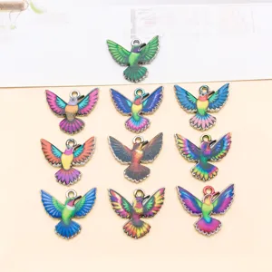 Close-up of colorful enamel hummingbird metal charms, perfect details for DIY handmade necklaces.