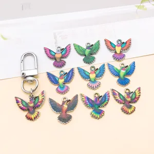 Close-up detail shot of colorful hummingbird zinc alloy enamel charms for DIY jewelry making.
