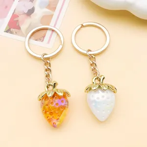 Cute 3D resin strawberry keychains with gold chains, stylish bag charms and DIY jewelry pendants.