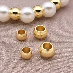 Macro shot of smooth gold-plated large hole spacer beads for DIY jewelry making.