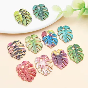Colorful enamel monstera leaf charms for DIY earrings and jewelry making, detailed view.