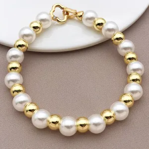 Detailed shot of elegant pearl and gold bead bracelet with smooth metallic spacer beads.