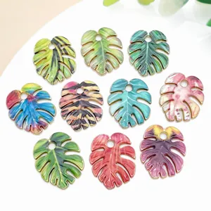 Colorful Monstera leaf enamel charms detail showcasing vibrant printed patterns and hanging loop.