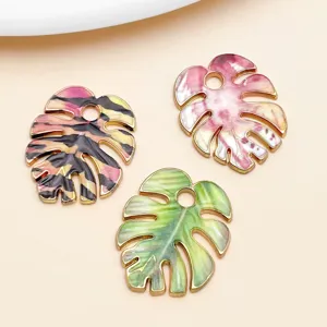 Colorful enamel monstera leaf pendant charms for DIY earrings and necklace jewelry making.