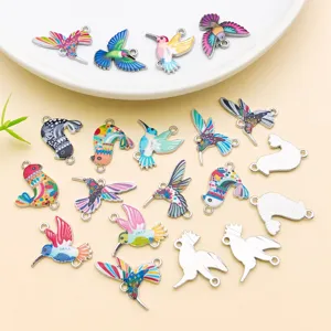 Hummingbird charm detail view showing colorful enamel and double loop alloy metal design.
