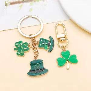 Close-up detail of St. Patrick's Day green clover and top hat alloy pendants and keychains.