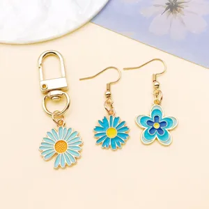Blue daisy flower enamel alloy keychain and earrings jewelry set detailed view close up accessories