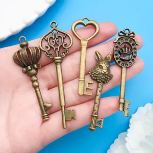Detail view of mixed vintage bronze alloy key pendants including crown, heart and rabbit charms.