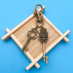 Vintage bronze alloy crown key pendant DIY jewelry accessory, detailed carved hollow design.