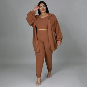 Plus size solid ribbed three-piece lounge set featuring a crop top, pants, and matching shirt.