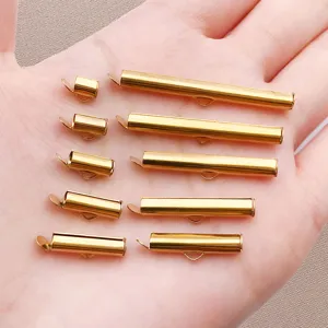 Detail view of golden slide tubes and connector pins for DIY handmade jewelry accessories.
