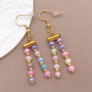 Colorful beaded drop earrings with gold tone hooks and multi color dangling beads detail.