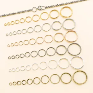 Detailed view of metal double jump rings in various colors and sizes for DIY jewelry making.