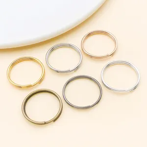 Close-up detail of multi-color metal split jump rings for DIY jewelry making and keychains.