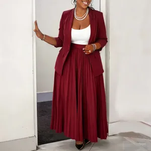 Detailed view of women professional blazer and pleated maxi skirt set in elegant burgundy.