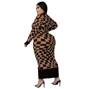 Plus size long sleeve maxi dress with optical checkerboard pattern and contrast black cuffs.