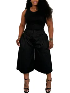 Detailed view of plus-size casual black tank top and pleated wide-leg shorts outfit set.