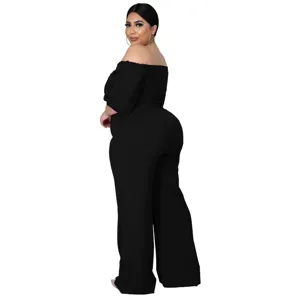 Close-up detail of the elegant off-the-shoulder black jumpsuit design and premium fit.