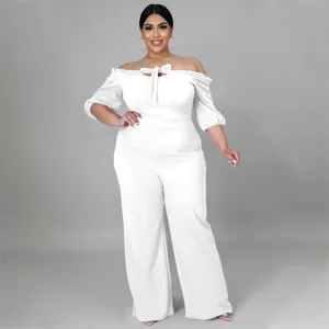 Details of the white off-the-shoulder plus-size jumpsuit with front bow tie and wide legs.