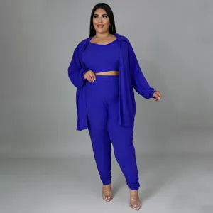 Plus size royal blue ribbed three piece lounge set featuring a crop top, pants, and long shirt.