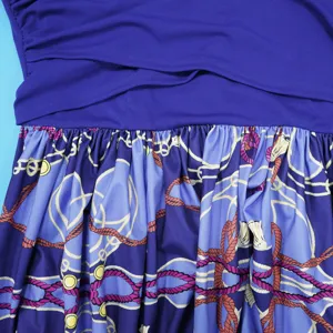 Close-up detail of purple pleated women dress featuring elegant nautical rope chain print.