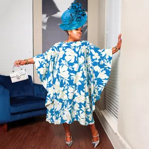 Detailed view of loose kimono sleeve plus size floral dress with matching hat and handbag.