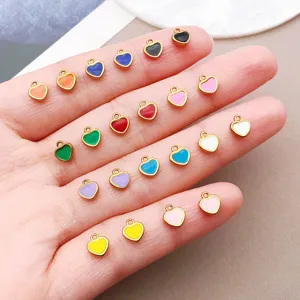 Close-up of colorful mini enamel heart charms, stainless steel DIY jewelry making accessories.