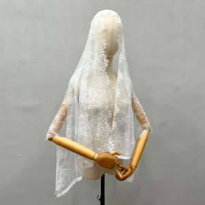 Detailed shot of white lace bridal veil, exquisite vintage floral design on mannequin.