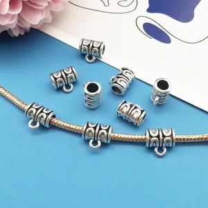 Close-up detail of silver DIY large hole bail beads, perfect for charm bracelet making.