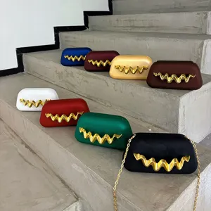 Matte finish evening box clutch bag with unique gold wave metal decor for women parties.
