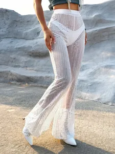 Close-up view of sheer mesh rhinestone flare pants showcasing sparkling details and high waist design.