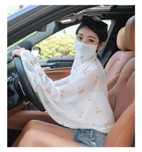 Detailed view of the sun protection shawl with cherry print worn inside the car interior.