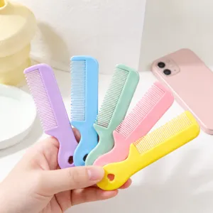 Close-up of mini candy color hair comb detail, portable cute plastic pocket comb for daily use.