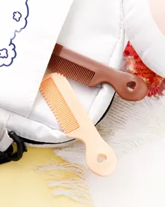 Mini portable plastic hair comb detail view, cute candy color compact hair styling tool for daily use.
