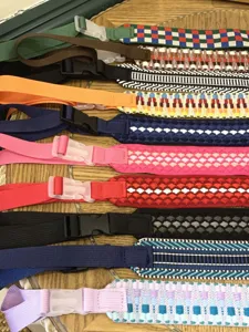 Detailed shot of adjustable woven nylon bag straps with geometric patterns for crossbody bags.