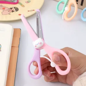 Detailed view of cute cat safety craft scissors with spring assist, pastel pink handle.