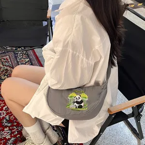 Grey nylon crescent shoulder bag with cute panda embroidery, versatile crossbody design.